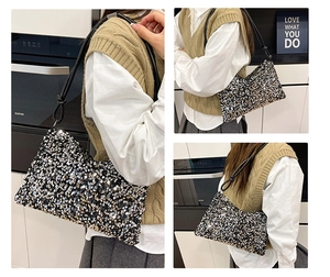 Detailed close-up of mixed black, gold and silver sequins on a stylish dumpling shoulder bag