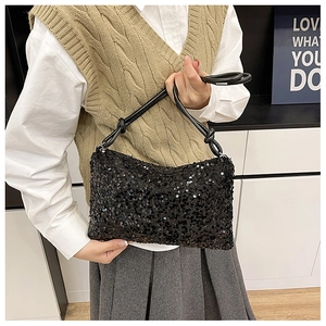 Detail of black sequined handbag with knotted leather strap showing shiny texture