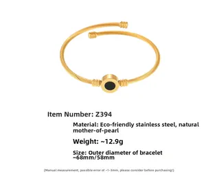 Detail of twisted cable gold bracelet with natural black shell inlay and sizing info