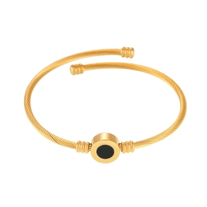 Gold stainless steel wire cable bracelet with black circular center and screw-end accents