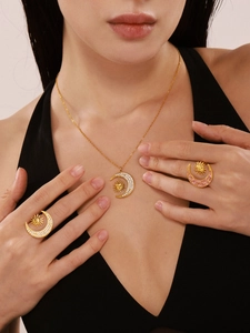 Detail of gold moon and sun jewelry set with pavé cubic zirconia on model