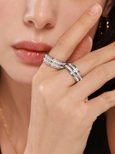 Close-up of double-row pavé crystals on silver eternity rings worn by a model