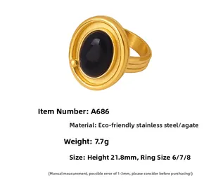 Detail of 18K gold-plated stainless steel ring with oval black agate stone inlay