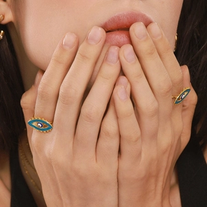 Artistic display of gold evil eye open rings with blue enamel and beaded details