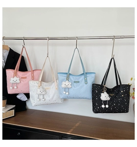 Detail view of four colorful tote bags with star prints and cute cloud charms