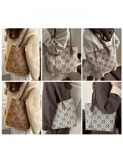 Detail view of large tote bags with M-pattern print and silk scarf handles in three colors