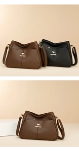 Detailed view of the kangaroo metal logo on textured leather crossbody bucket bags