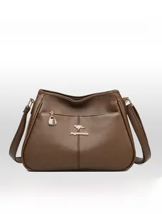 Detailed macro view of litchi grain leather and kangaroo metal logo on brown bucket bag