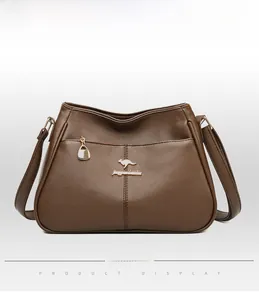 Detail of brown leather bucket bag with litchi texture and metal kangaroo logo