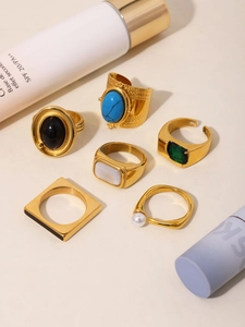 Detailed set of six vintage gold-tone rings featuring emerald, pearl, and turquoise accents