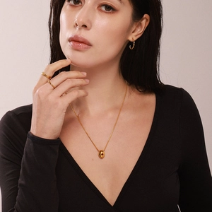 Gold necklace and earring set with red zircon pendant and wave rings for women