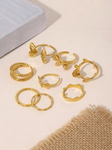 Detailed view of a 7-piece vintage gold-plated ring set with butterfly and rose designs