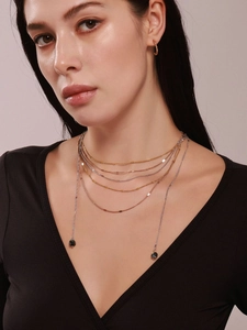 Close-up of layered titanium steel chain with natural volcanic stone tassel on model