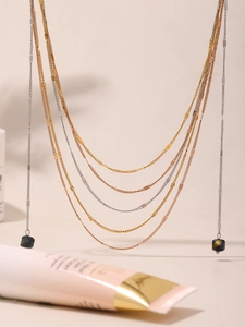 Detail of multi-layer titanium steel chain with square natural volcanic stone pendant