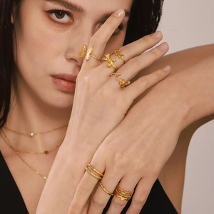Minimalist 18K gold-plated irregular rings with butterfly and flower designs on model