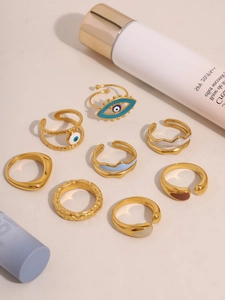 Macro view of 8-piece gold-plated ring set with evil eye motifs and colorful enamel