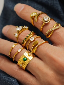 Close-up of a stacked gold ring set with cubic zirconia on denim background