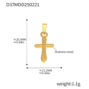 Macro detail of gold-plated stainless steel cross pendant with diagonal textured engraving