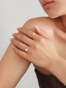 Close-up of model wearing two 18k gold plated halo rings with sparkling 5A zircon stones