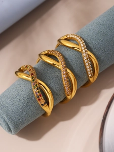 Detailed view of three 18K gold plated crisscross rings with colorful zircon stones