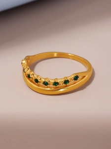 Detail of 18k gold plated ring with dual-layered band and inlaid green zircons