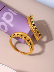 Close-up of double layered 18k gold plated rings featuring inlaid green zircon stones