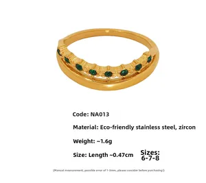 Close-up of double-layered 18k gold plated ring featuring seven green cubic zirconia stones