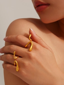 Detail of 18K gold-plated liquid style rings with irregular organic flowing shapes on model
