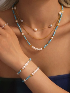 Detail of layered freshwater pearl and blue turquoise bead necklace set for women