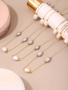 Detail of handcrafted freshwater baroque pearl necklace on a delicate gold chain