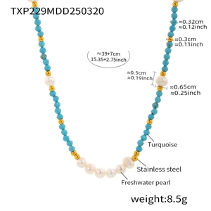 Detail of turquoise beads and freshwater pearl necklace with stainless steel accents
