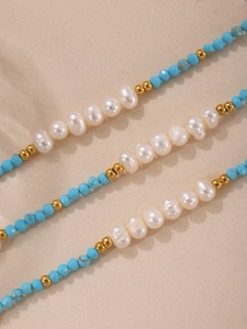 Macro view of handmade turquoise beads and natural freshwater pearl necklace details