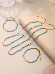 Detail of turquoise beads and pearls jewelry set with stainless steel clasps