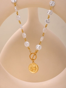Detail of baroque pearl necklace with Elizabeth II coin pendant and gold OT toggle clasp