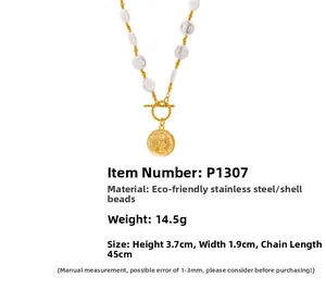 Detail of vintage coin pendant necklace with shell beads and golden stainless steel OT toggle