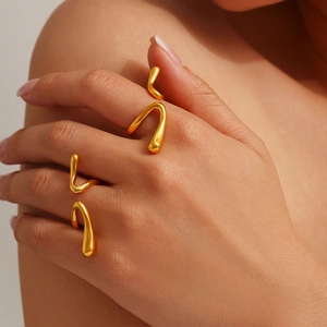 Polished liquid-look golden irregular wavy open rings set in a modern minimalist style