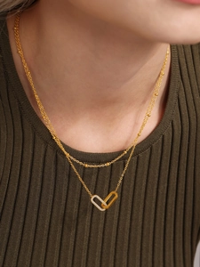 Detailed view of a gold double-layered necklace with interlocking zircon-set circles