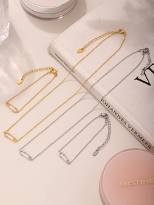 Detail of safety pin necklaces and bracelets with 5A zircon in gold and silver finish