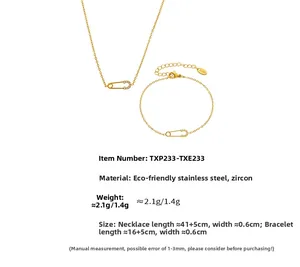 Detail of gold safety pin pendant necklace with zircon inlay and stainless steel texture