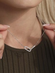 Detail showing a silver double interlocking rectangle necklace set with white zircons