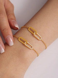 Macro detail of gold layered bracelet with interlocking rings and cubic zirconia pavé