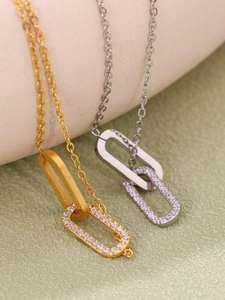 Detail of interlocking geometric necklaces with polished finish and pavé cubic zirconia
