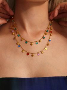 Close-up of double-layer gold necklace featuring vibrant colorful heart enamel pendants