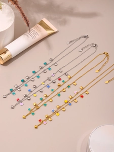 Detail of colorful enamel heart pendants on gold and silver stainless steel necklaces