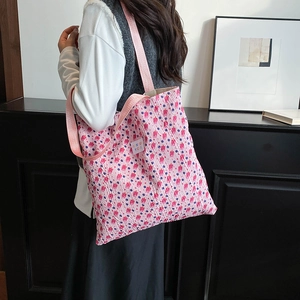 Pink floral tote bag with textured puckered fabric and floral patterns for daily use