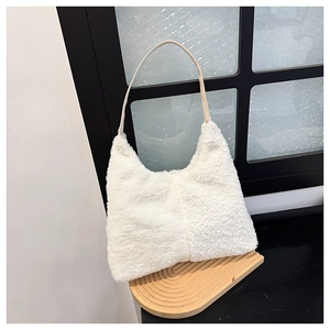 Detail of white fluffy plush faux fur hobo bag with slim leather shoulder strap