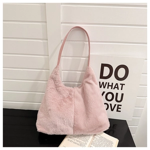 Close-up of soft pink faux fur material and premium leather handle on a plush shoulder bag