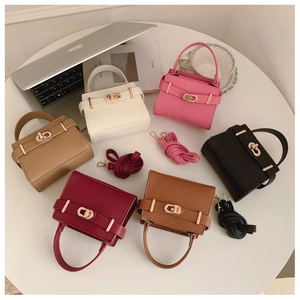 Overhead layout of luxury textured leather handbags in multiple colors with gold clasps