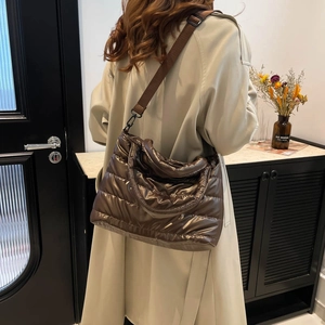 Quilted metallic puff shoulder bag in deep chocolate brown with wide webbing strap