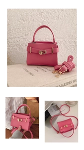 Detailed view of pink lychee leather handbag featuring a gold clasp and crossbody strap